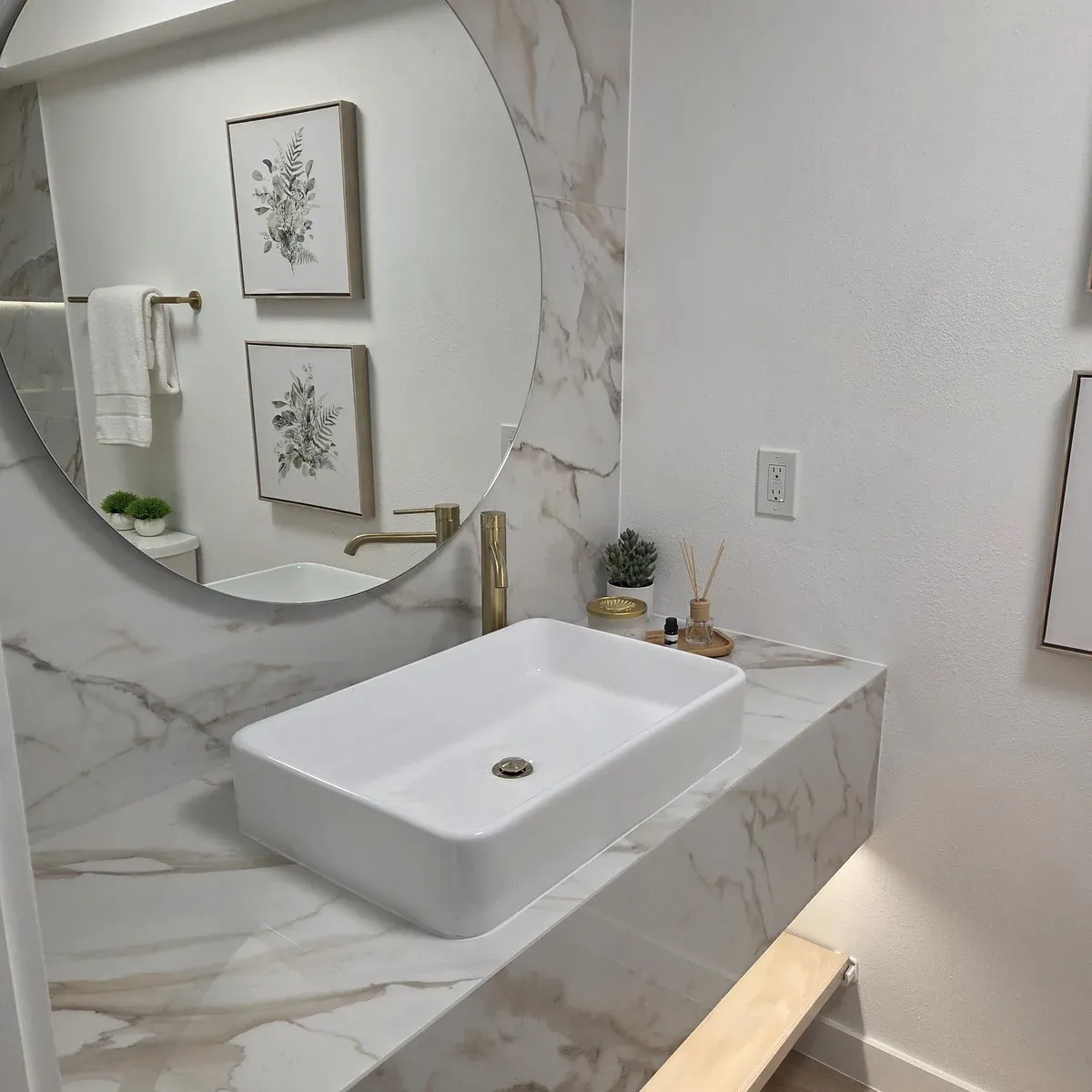 Marble bathroom vanity with round mirror
