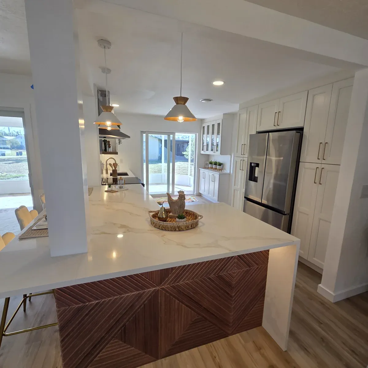 Modern kitchen with marble backsplash and wood accent