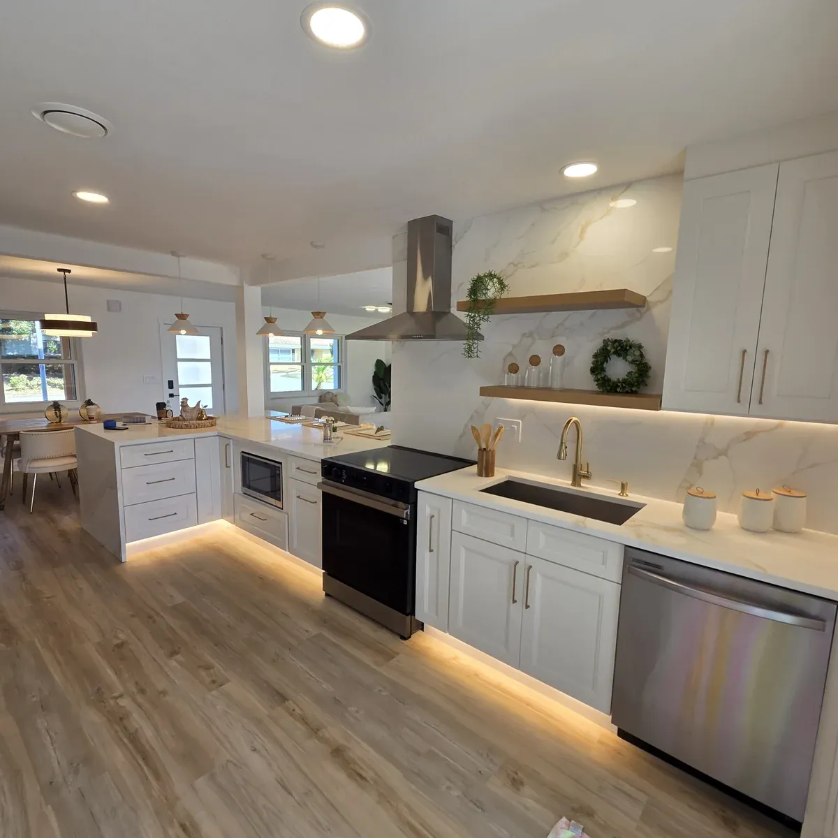 Modern white kitchen with vinyl plank flooring